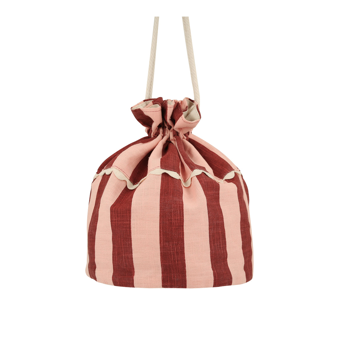 Our cotton bag, an adorable accessory for kids, looks like a big top and has an embroidered lion detail.