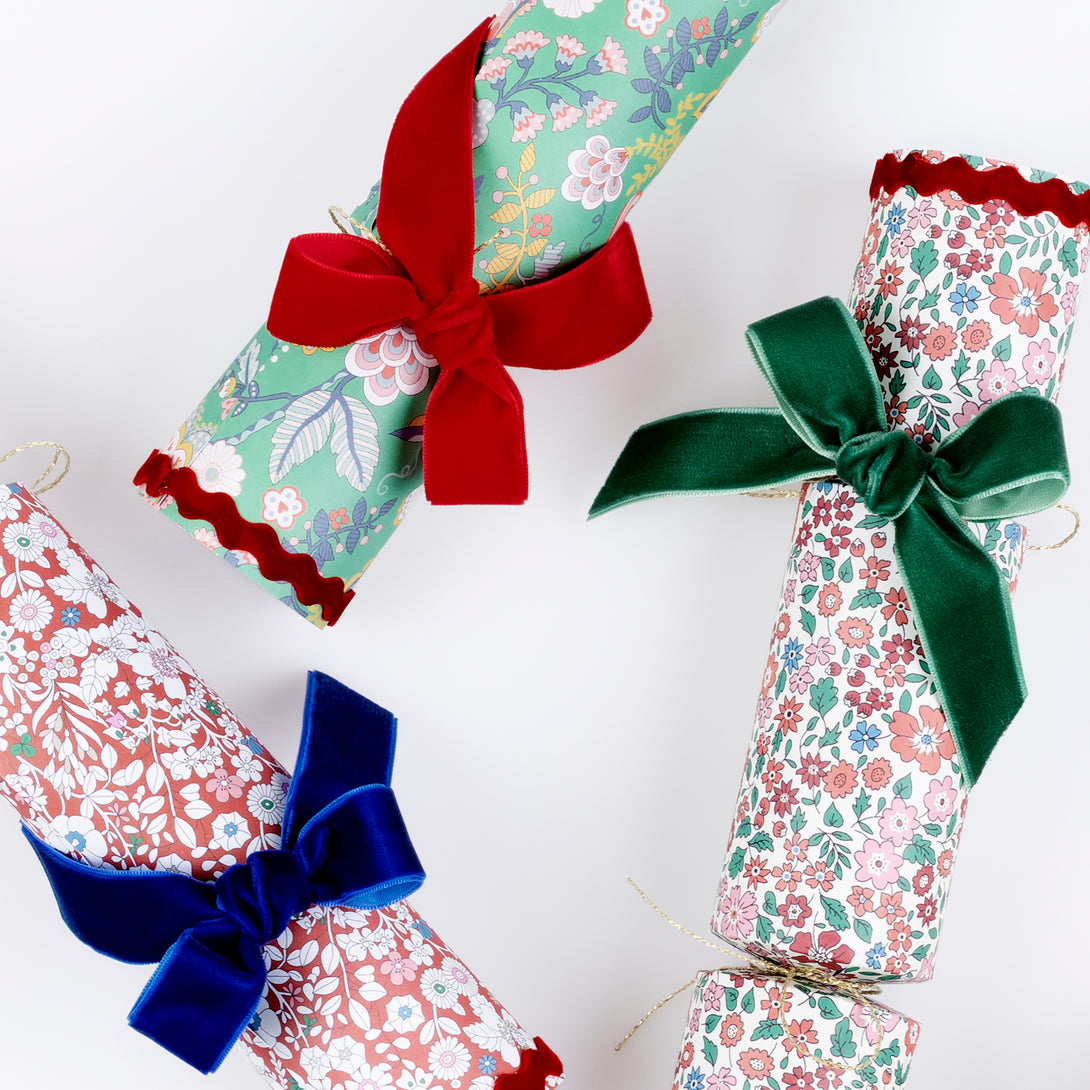 Our stunning luxury Christmas crackers feature joyful Liberty prints and velvet bows, with a selection of gifts inside, and no-snap for a silent pull. Image4