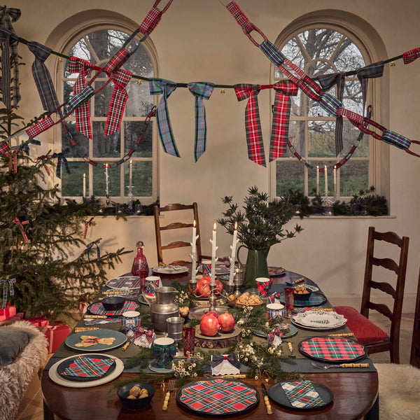 Our statement Christmas garland features large tartan bows with tinkling bells, perfect for hanging wherever you want seasonal sophistication. Image2