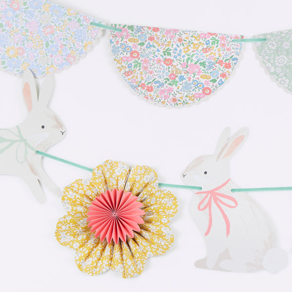 Our Easter decoration set includes 2 paper garlands with Liberty floral design flower pinwheels and scalloped shapes, and Easter bunnies. Image2