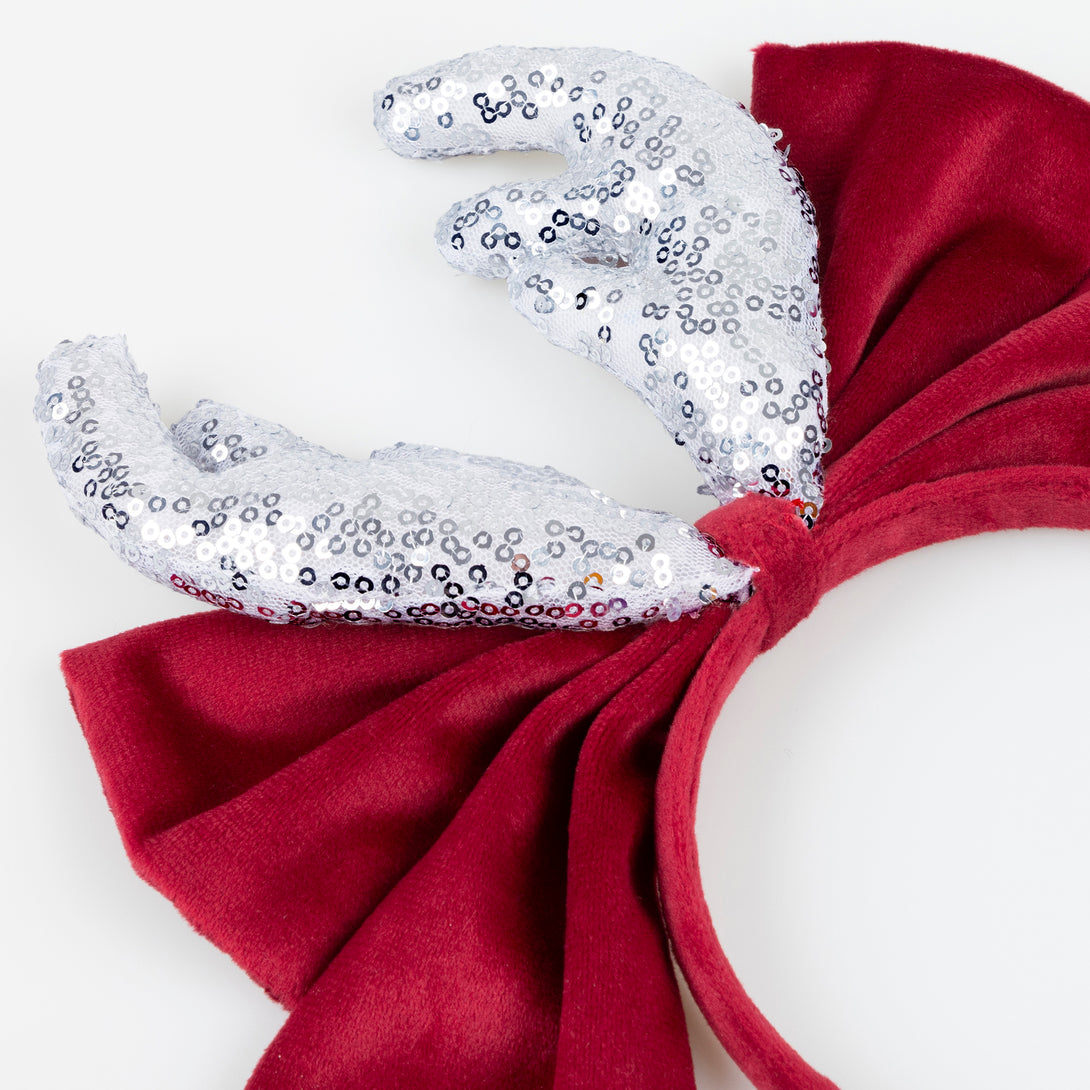 Our reindeer headband is a fabulous accessory to wear to Christmas parties, with silver sequin antlers, and a red velvet bow and headband. Image3