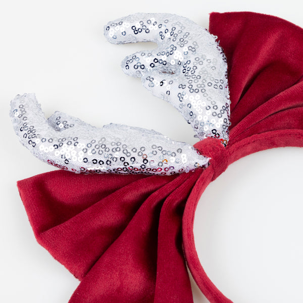 Our reindeer headband is a fabulous accessory to wear to Christmas parties, with silver sequin antlers, and a red velvet bow and headband. Image3