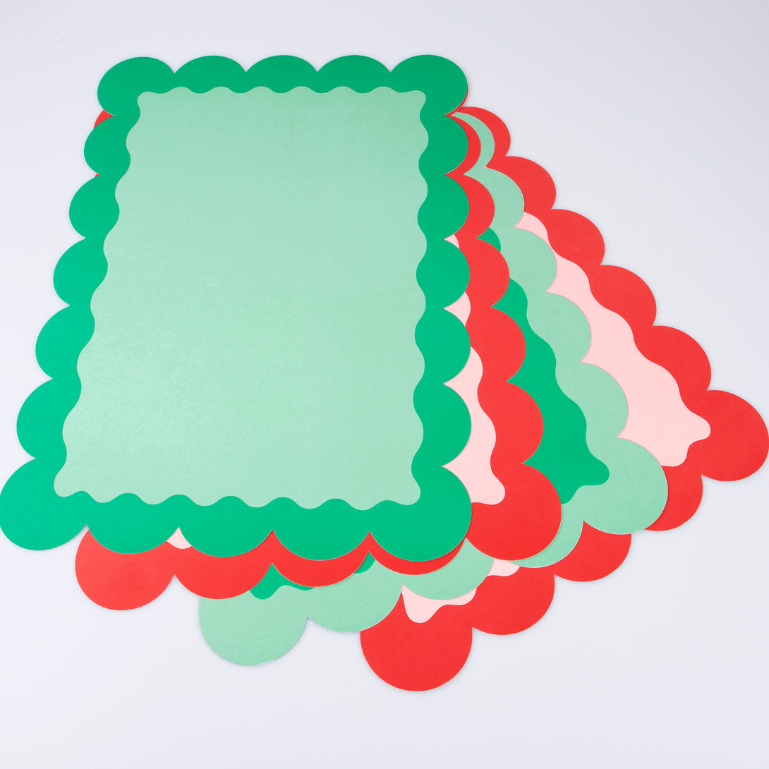 Our paper placemats are crafted in Christmas colours of red and green, with a modern pop of pink, and stylish scalloped edges.