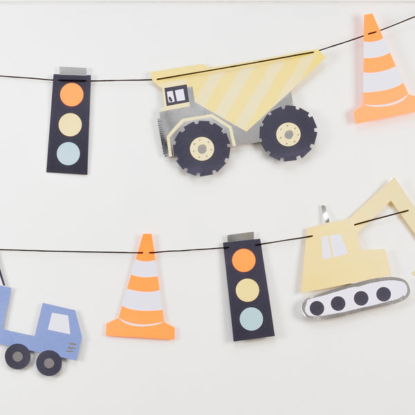 Our construction party supplies include paper plates, a 3D garland, cups, napkins, hats and a cupcake kit.  Image3