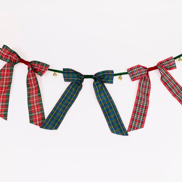 Our statement Christmas garland features large tartan bows with tinkling bells, perfect for hanging wherever you want seasonal sophistication. Image3