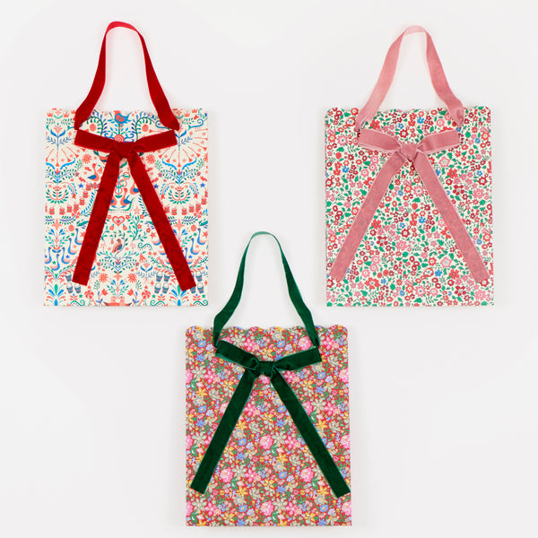Our paper Christmas gift bags feature beautiful Liberty print designs for an elegant look, with three designs, velvet ribbon bows and handles. Image3