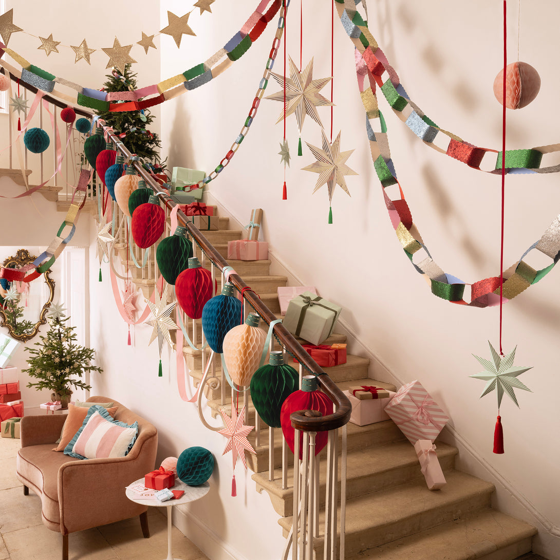 Our Christmas garland, made from honeycomb paper, features 3D details of fairy light designs in festive colours. Image2