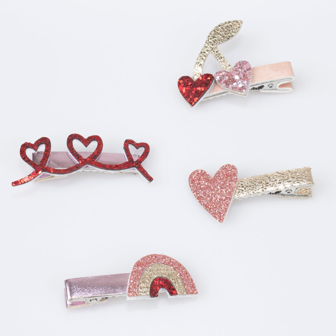 Our glitter hair clips, with pink and red glitter fabric, hearts, bows and a rainbow, are perfect as Valentine's gifts.