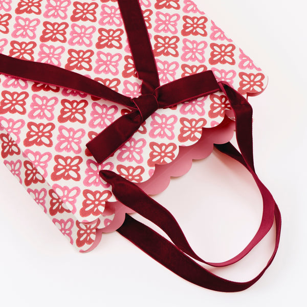 Our medium Christmas gift bags, made from premium paper, feature Molly Mahon block print designs with velvet bows and handles. Image2