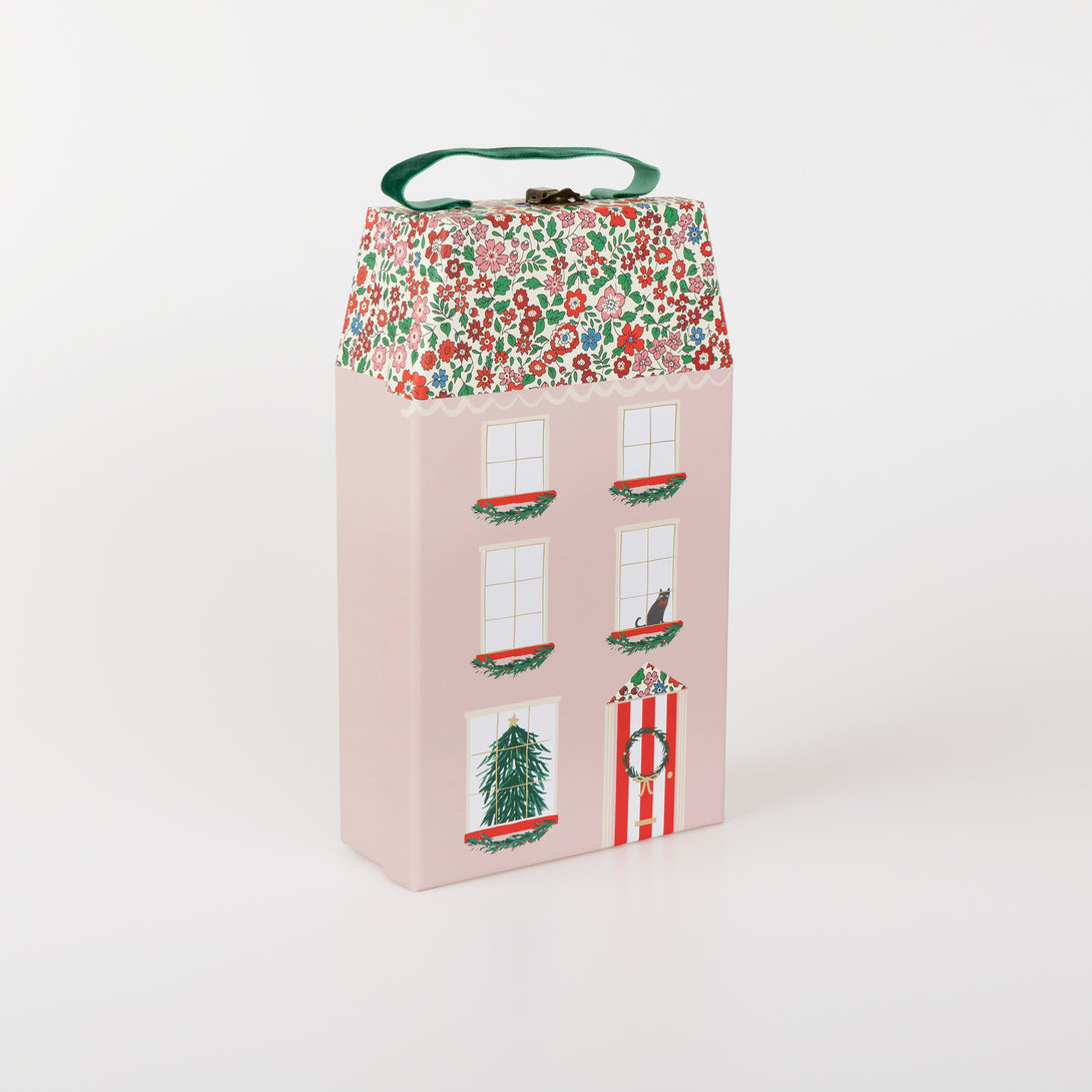 Our luxury advent calendar is designed as a suitcase-style box, with Liberty floral print details, inside which is a bracelet and charms Image1