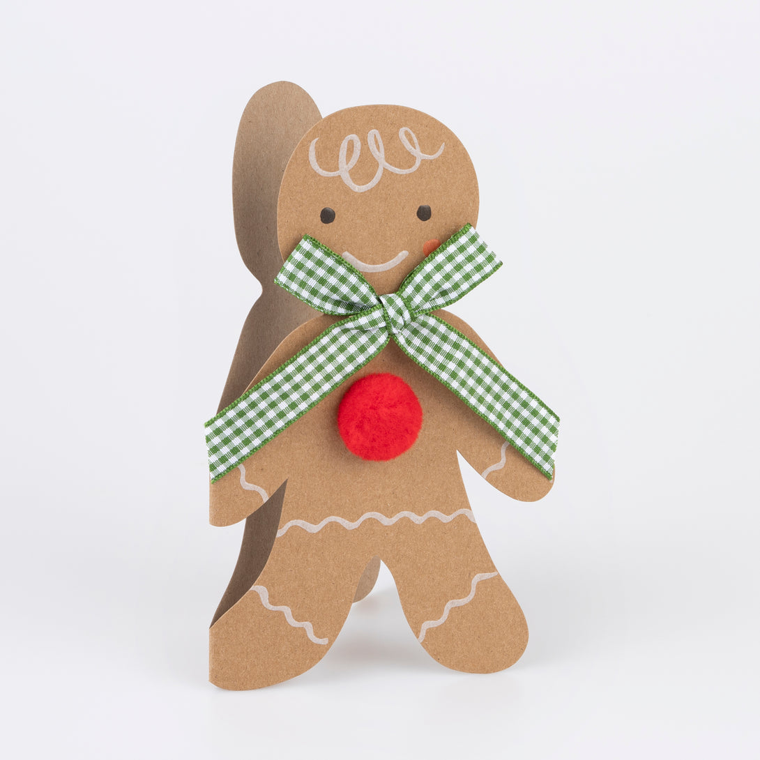 Our Christmas card, in the shape of a gingerbread man with a gingham ribbon bow, makes a great Christmas mantel decoration.