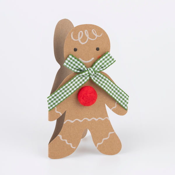 Our Christmas card, in the shape of a gingerbread man with a gingham ribbon bow, makes a great Christmas mantel decoration.