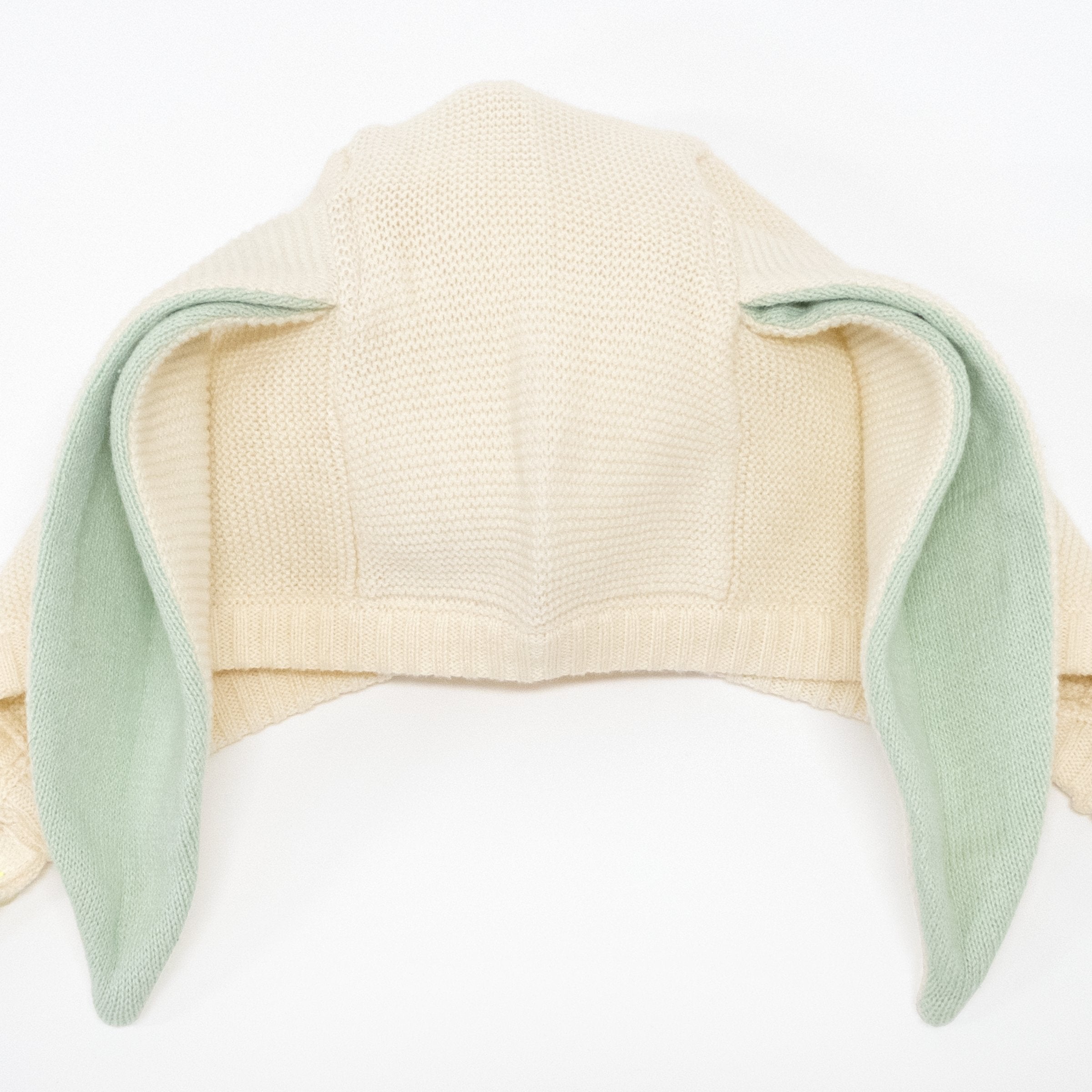 This delightful bunny baby bonnet is crafted from knitted organic cotton, with mint detail on the ears, and fastens with ivory coloured buttons.