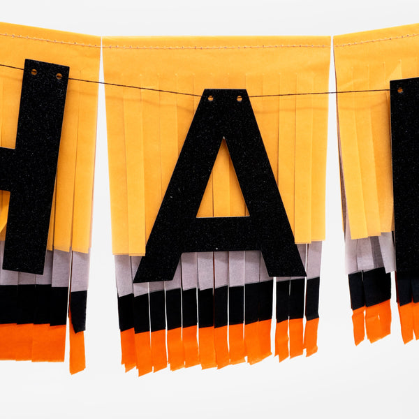 Our fringed paper garland, with Happy Halloween wording, is the perfect Halloween party decoration. Image2