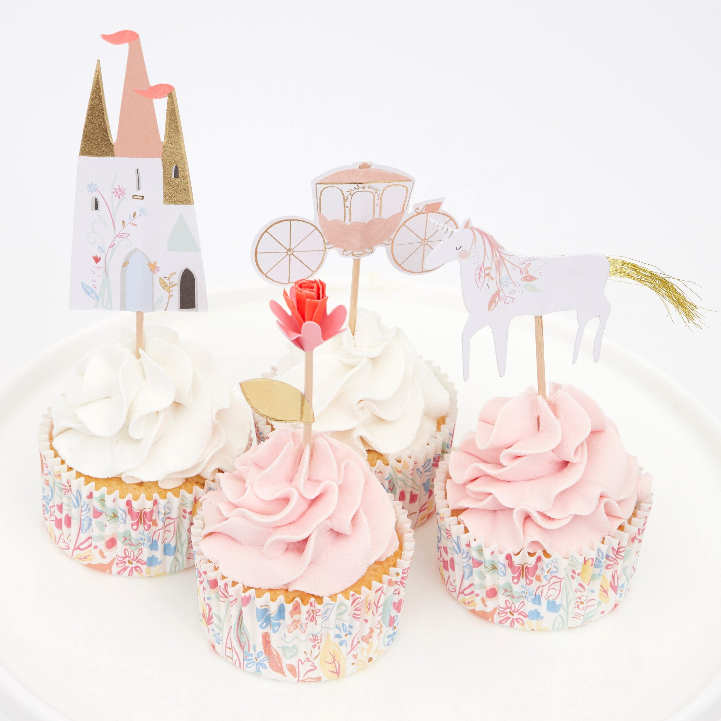 This princess cupcake kit includes carriage, flower, castle and unicorn cake toppers and coordinating cupcake cases.
