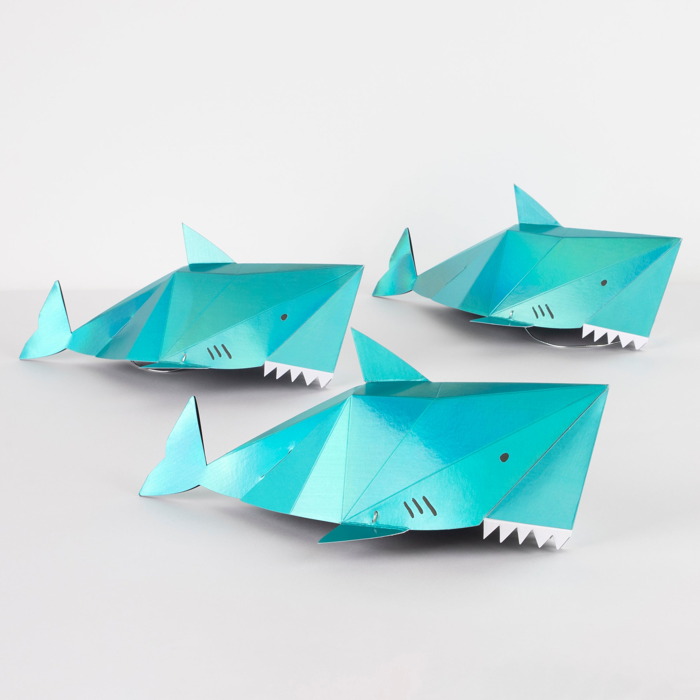 Our hats in the shape of a shark make spectacular paper party hats.