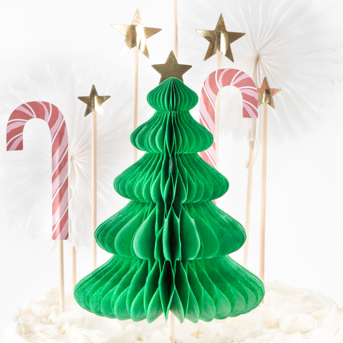 Our Christmas cake decorations include gold glitter star cake toppers and a honeycomb 3D Christmas tree.