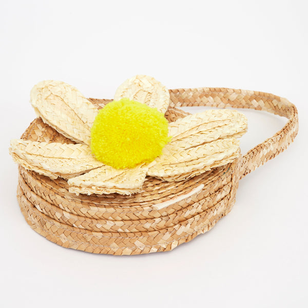 This sensational straw kids bag has a raffia daisy with a yellow pompom in the centre. Image2