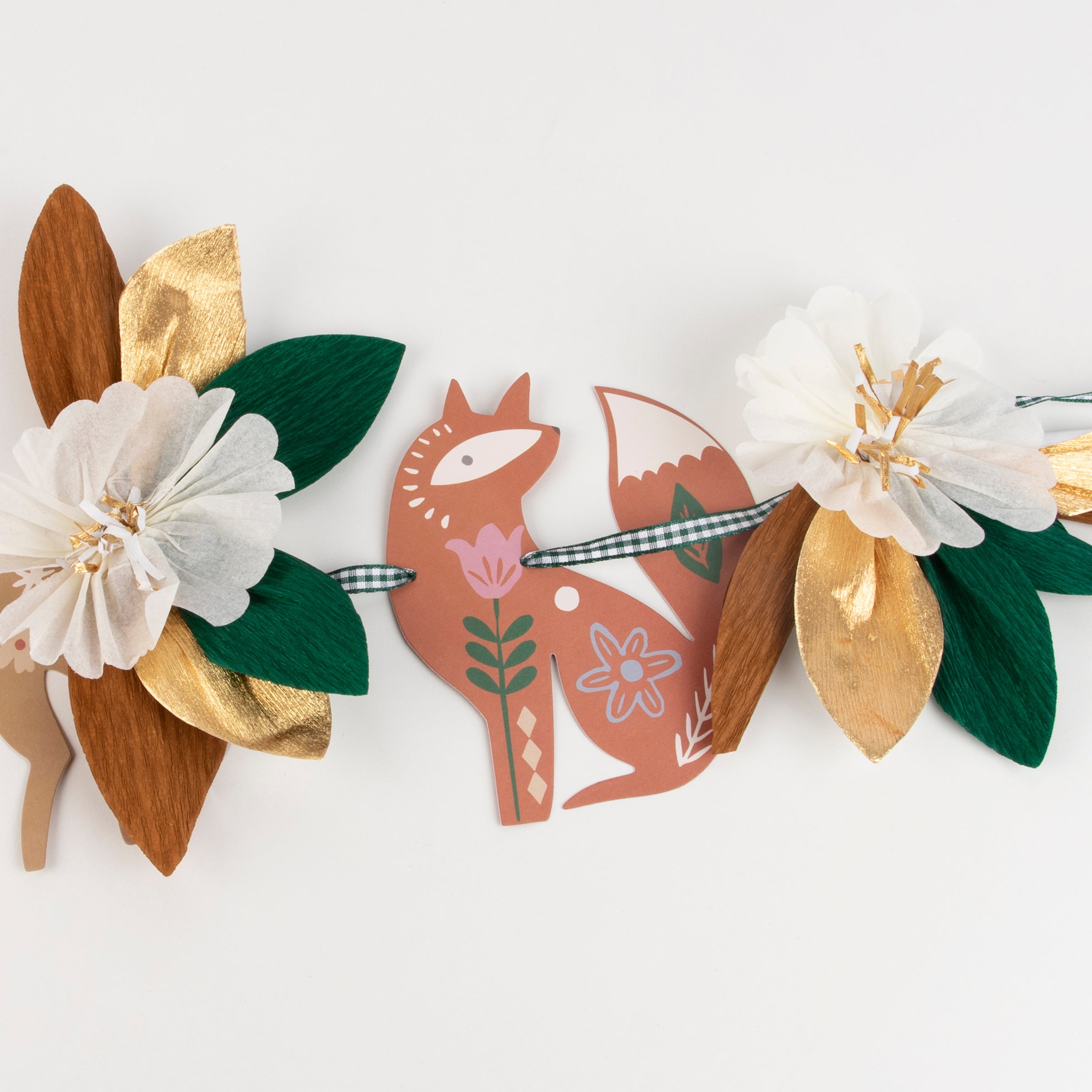 This beautiful autumn garland is made from crepe paper decorations including flowers and leaves.