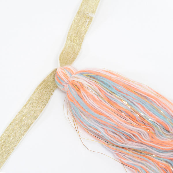 This kids' unicorn costume features a headband with a felt unicorn horn and ear details, and a swishy tail. Image3